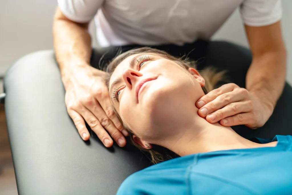 Physiotherapist working on womans neck